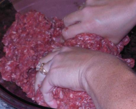 I find that mixing the meat by hand better distributes the seasoning throughout the meat.