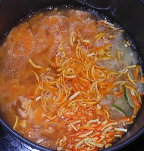 I added everything, except for the sugar, to the pan and turned on the heat.  Then I looked at the instructions again and realized that this needed to simmer and then sit for 12-18 hours.  So I simmered the orange mixture and turned the heat off on my water bath canner containing the jars.