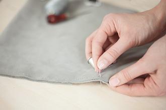 hand stitching a DIY tablet case