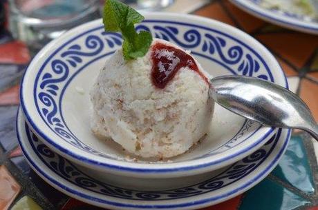 Ice cream with pecans and raspberry sauce. 