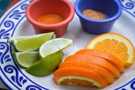 Traditional condiments for mezcal: salt with arbol chiles, sal de gusano, lime, and oranges.