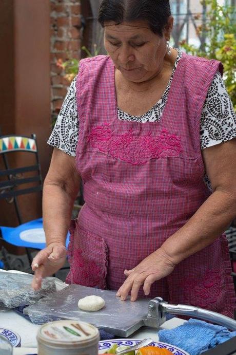 Doña Libo Gomez creates all of the recipes. Here, she demonstrates making tortillas by hand. 