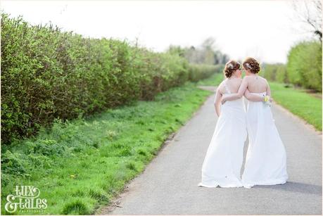 Two brides same sex wedding in York walking down leafy lane