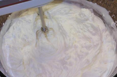 After another minute or so, the whipped cream was getting really thick.  You can tell it's ready when you lift the beaters or whisk out of the cream and the 