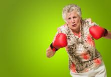 Angry Mature Woman Wearing Boxing Glove