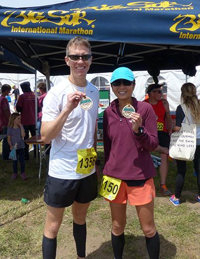 Mike Sohaskey and Jen with Big Sur International Marathon finisher's medallions