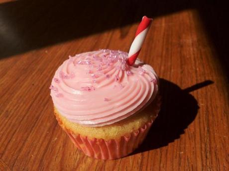 pink lemonade cupcake swirl icing with red and white edible straw