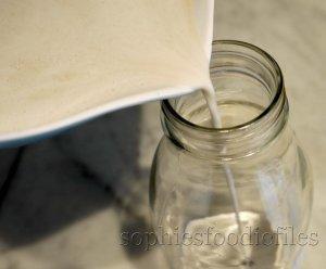 8/ Pouring the strained sunflower seed milk in a lovely clean bottle!