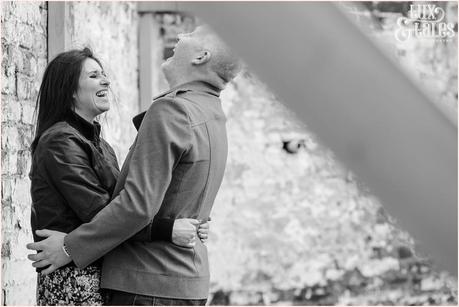 Laughing couple at engagement shoot