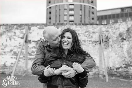 Engagement shoot in front of peeling brick wall