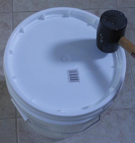 Using a rubber mallet, I put the lid on my bucket.