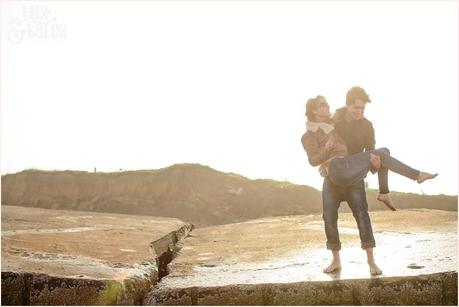 playing on the bunker in the sunset at Fraisthorpe beach engagement shoot