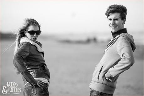 couple makes silly faces at Yorkshire beach engagement shoot
