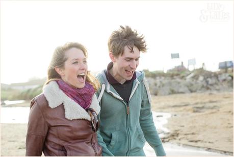 laughing and smiling couple at engagement shoot at Yorkshire beach