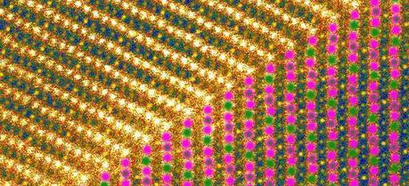 At top of this image a, sodium fills in layers of the crystal, represented by one bright yellow dot followed by three darker ones; at bottom, the layers’ magnetic ordering is shown as green and purple dots representing magnesium at two different charge states, with the green-in-purple dots representing a mixture of the two charge states. Artwork generated from a scanning tunneling microscope image.