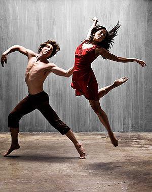A man and a woman performing a modern dance.