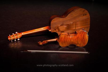Photo - guitar, fiddle and fiddle bow on a black background