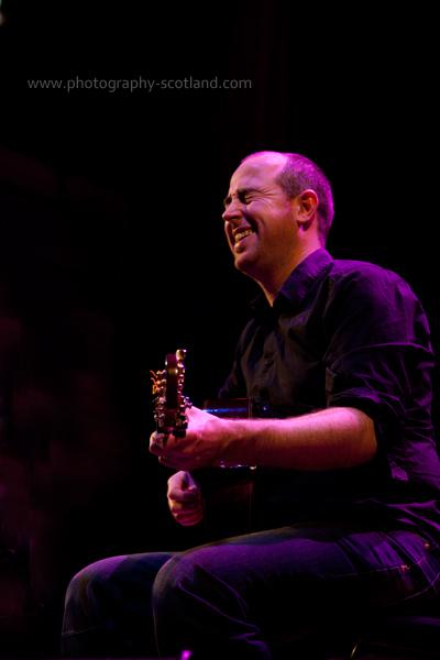 Picture - Tony Byrne, guitarist, playing at the Scots Fiddle Festival in Edinburgh, Scotland