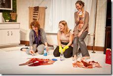 Ginger (Anna Carini, left) and Amelia (Calliope Porter, center) cheer-up Amy (Cyd Blakewell, right) while they clean up after their friend's accident in SiNNERMAN Ensemble's Sweet Confinement, by Anna Carini, directed by Brea Hayes. Photo by Ben Chandler. 