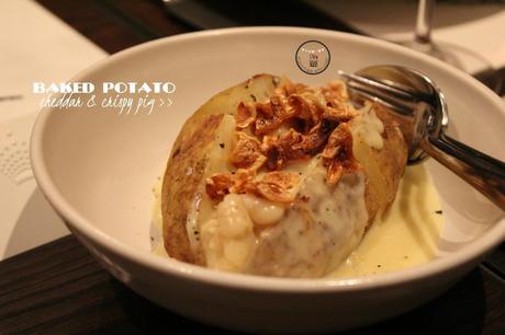 baked potato with cheddar and crispy pig