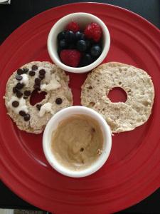 Bagel thins topped with coconut butter and stevia chocolate chips. Side of Sunwarrior protein 'frosting' and berries. 
