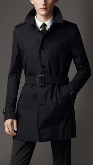 The Literary James Bond A modern navy blue Burberry trench coat, likely the very item Bond would wear if Fleming was writing about him today. Note that the model is wearing a very Bondian white shirt and black tie.