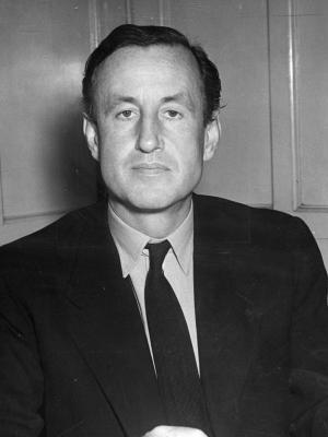 The Literary James Bond Ian Fleming in a dark suit and knitted necktie, a rare sight given his preference for bow ties later in life.