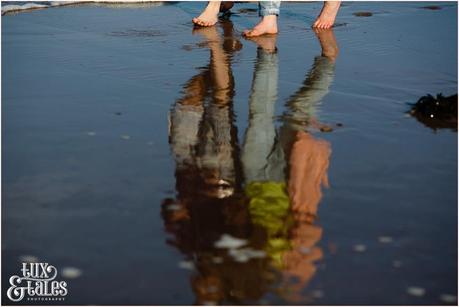 couple walking on the beach in Scarborough