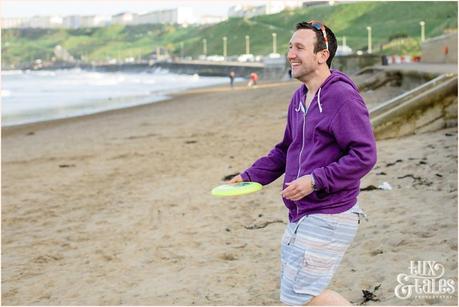 Playing frizbee at Scarborough beach engagement shoot