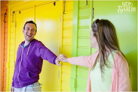 Eun engagement photography with colourful beach huts at North Beach Scarborough Yorkshire 