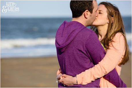 Couple kissing in front of the beach at North Beach Scarborough