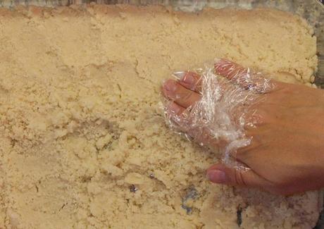 I pressed the crust mixture into a 9x13 pan.  TIP: Rather than use a spoon, I put a little plastic wrap around my fingers and use my hands to press the dough into the pan.  I use the plastic wrap, so the dough doesn't stick to my hands.