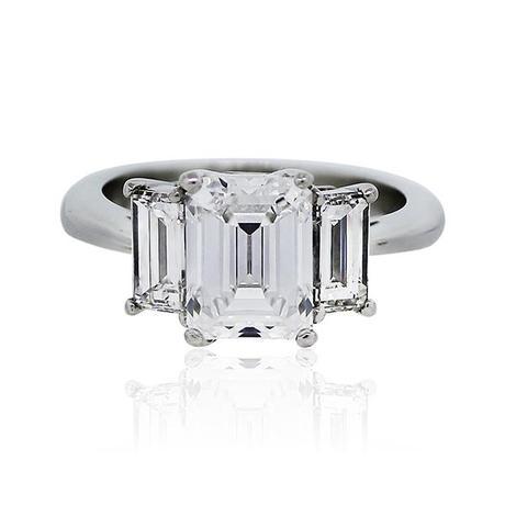 Three stone emerald cut engagement ring
