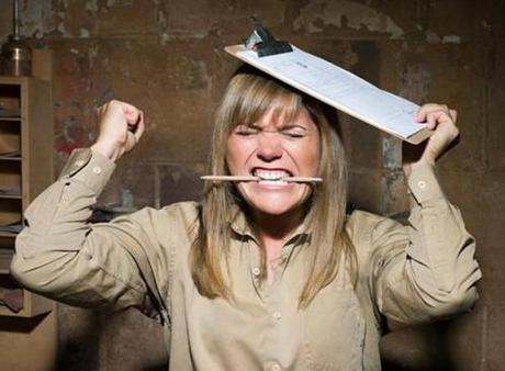 Angry woman biting a pencil