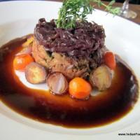 Lamb confit with red onion jam and glazed vegetables