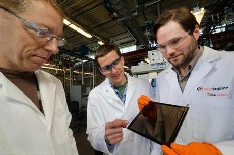 Dr. Scott Hammond (right) and NREL researchers examining a grey-brown tinted SolarWindow module