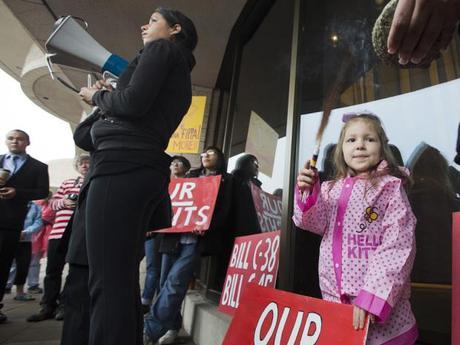 Kharis Bercier, 4, fans the sweet grass as the Idle No More movement holds a demonstration at the Museum of Civilization in Gatineau Quebec to draw attention to the First nations point of view on the 250th anniversary of the Royal Proclamation of 1763 governing land use in Canada. Photo: Wayne Cuddington / Postmedia News