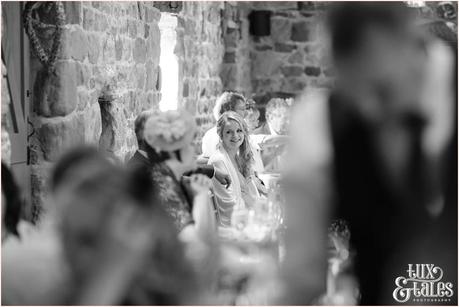 Sister of bride looks on and smiles at The Ashes wedding