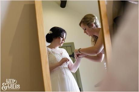 Bridesmaid puts on jewelry 