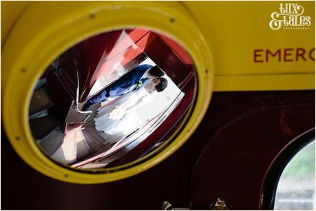 Reflection of bride & gtoom in the mirror of a bus