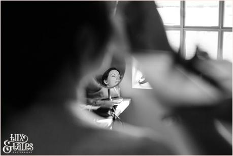 Bride having makeup applied in mirror at The Ashes wedding 