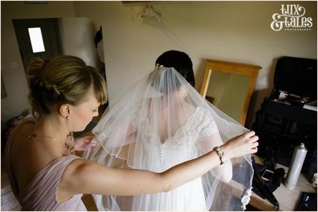 Bridesmaid fluffs the brides veil at The Ashes in staffordshire