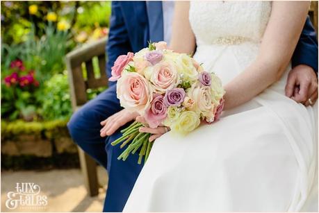 Bride & groom holding bouquet at the Ashes