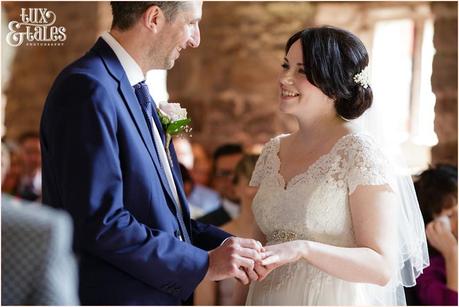 Bride & groom exhange rings at the Ashes wedding venue