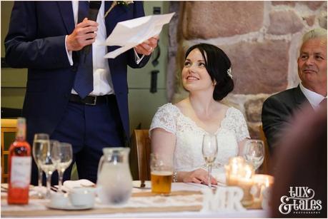 Bride looks at groom during the speeches at The Ashes wedding 