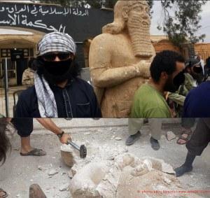 ISIS militants destroying Assyrian artifacts found in Raqqa.