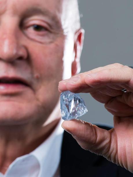 Petra Diamonds CEO Johan Dippenaar holds a 122.52-carat rare blue diamond