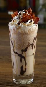 Twist & Shout Shake: Bacardi Oakheart Spiced Rum, Guinness, DeKuyper Dark Creme de Cacao, chocolate syrup, vanilla ice cream and Monin Salted Caramel. Topped with whipped cream, caramel, chocolate syrup, and bacon pieces.