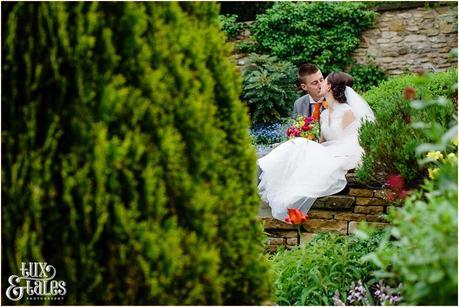 Bride & groom kissing at quirky wedding in yorkshire moors