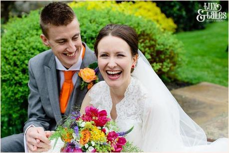 Bride and groom laugh and smile at Yorkshire wedding